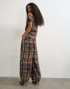 Model wearing Co ord pleated trouser in check