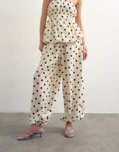 Model wearing Co ord polka dot balloon trouser in white