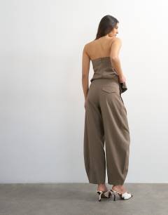 Model wearing Co ord raw hem barrel leg tailored trouser in brown