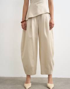 Model wearing Co ord raw hem barrel  leg tailored trouser in stone