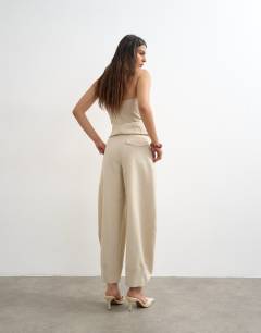 Model wearing Co ord raw hem barrel  leg tailored trouser in stone