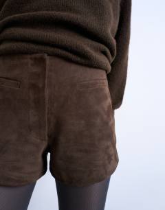 Model wearing Co ord real suede mini shorts in chocolate