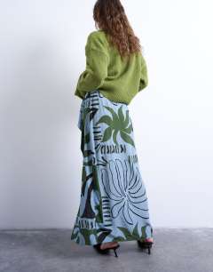 Model wearing Co ord sarong maxi skirt in blue abstract leaf print