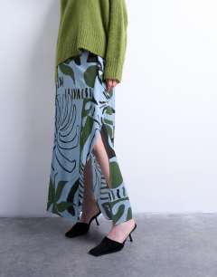 Model wearing Co ord sarong maxi skirt in blue abstract leaf print