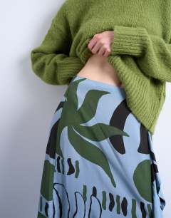 Model wearing Co ord sarong maxi skirt in blue abstract leaf print