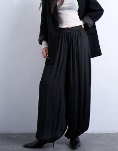 Model wearing Co ord satin deep waistband balloon trouser in black