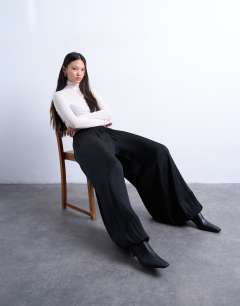 Model wearing Co ord satin deep waistband balloon trouser in black