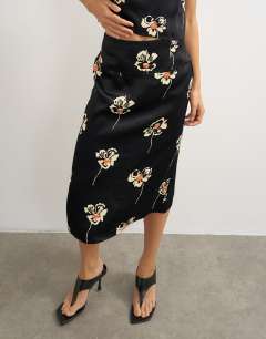 Model wearing Co-ord satin midi skirt in floral print