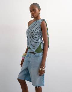 Model wearing Co ord scarf print one shoulder top in blue abstract leaf print