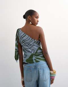 Model wearing Co ord scarf print one shoulder top in blue abstract leaf print