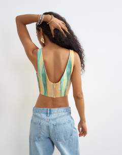 Model wearing Co-ord scoop cropped cami in orange abstract stripe