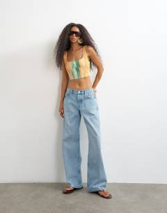 Model wearing Co-ord scoop cropped cami in orange abstract stripe