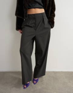 Model wearing Co ord stripe double pleat tab trouser in brown and black stripe