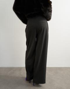 Model wearing Co ord stripe double pleat tab trouser in brown and black stripe