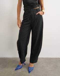 Model wearing Co ord stripe tailored pleat detail low rise trouser in black