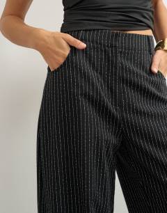 Model wearing Co ord stripe tailored pleat detail low rise trouser in black