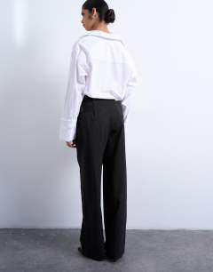 Model wearing Co ord subtle pinstripe low rise buckle detail trouser in dark chocolate