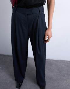 Model wearing Co ord subtle pinstripe low rise buckle detail trouser in navy