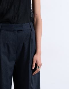 Model wearing Co ord subtle pinstripe low rise buckle detail trouser in navy