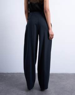 Model wearing Co ord subtle pinstripe low rise buckle detail trouser in navy
