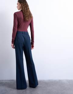 Model wearing Co ord tailored flare trouser in navy