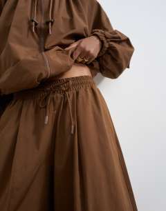 Model wearing Co ord techy lightweight ovoid trouser in chocolate