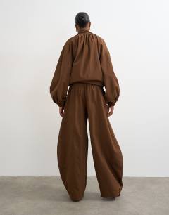 Model wearing Co ord techy lightweight ovoid trouser in chocolate