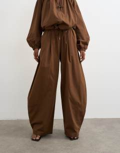 Model wearing Co ord techy lightweight ovoid trouser in chocolate