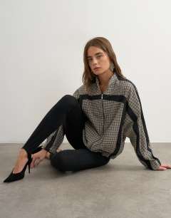 Model wearing Co-ord techy long sleeved zip through top in green check