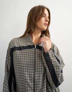 Model wearing Co-ord techy long sleeved zip through top in green check