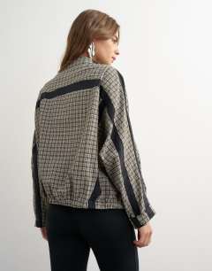 Model wearing Co-ord techy long sleeved zip through top in green check