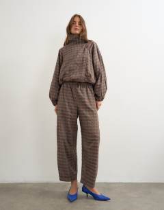 Model wearing Co-ord techy trouser in brown check