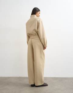 Model wearing Co ord twisted seam slim trouser in sand