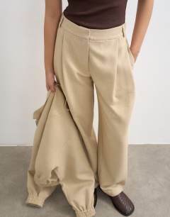Model wearing Co ord twisted seam slim trouser in sand