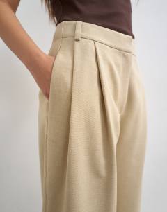 Model wearing Co ord twisted seam slim trouser in sand