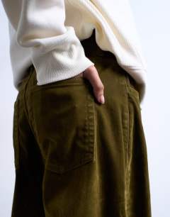Model wearing Co ord velvet barrel leg seam detail trouser in khaki