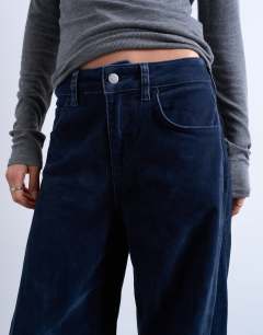 Model wearing Co ord velvet barrel leg seam detail trouser in navy