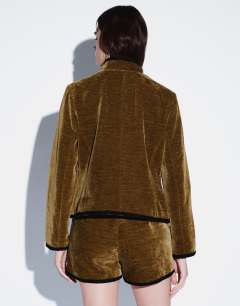 Model wearing Co-ord velvet knot detail jacket with nero collar in green