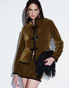 Model wearing Co-ord velvet knot detail jacket with nero collar in green
