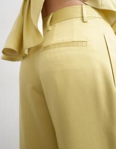 Model wearing Co ord wedding guest occasion pleated slouchy leg trouser in buttermilk