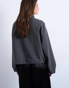 Model wearing Co rd funnel neck jacket in charcoal stripe