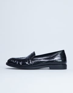Model wearing Coby ruched toe croc loafer in black