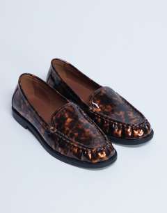 Model wearing Coby ruched toe loafer in tortoise shell