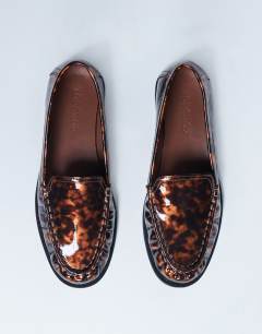 Model wearing Coby ruched toe loafer in tortoise shell