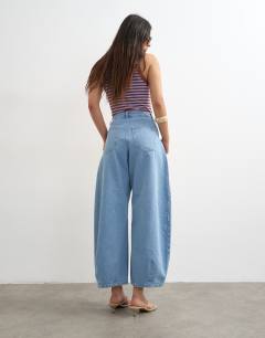 Model wearing Cocoon mid rise barrel jean in bleach