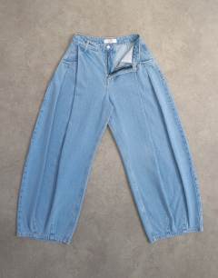 Model wearing Cocoon mid rise barrel jean in bleach