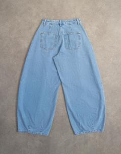 Model wearing Cocoon mid rise barrel jean in bleach