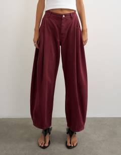 Model wearing Cocoon mid rise barrel jean in cherry red