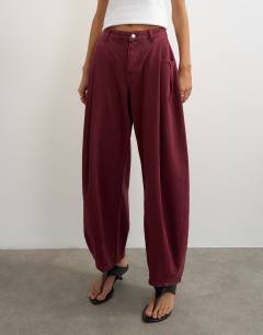 Model wearing Cocoon mid rise barrel jean in cherry red