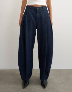 Model wearing Cocoon mid rise barrel jean in dark rinse